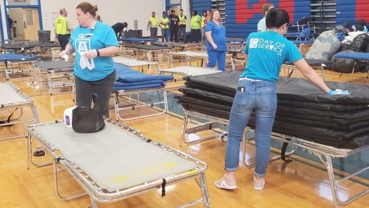 Volunteers put up cots