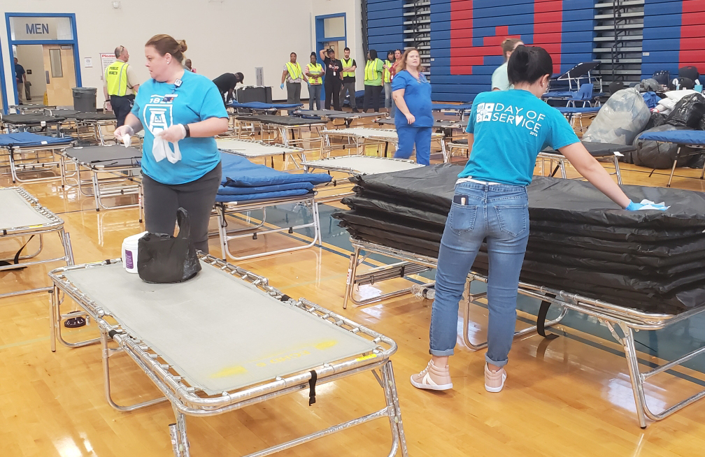 Volunteers put up cots