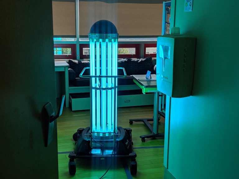A robot giving off UV light in a hospital room.