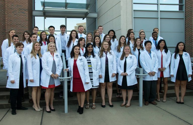 group photo of students with white coats