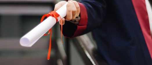 hand holding a diploma
