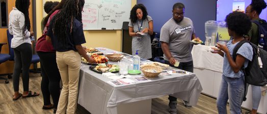 students gathered around a table eating