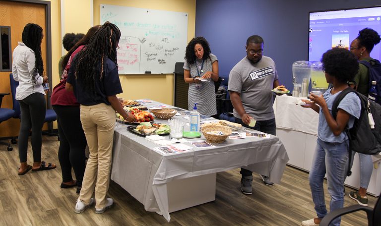 students gathered around a table eating