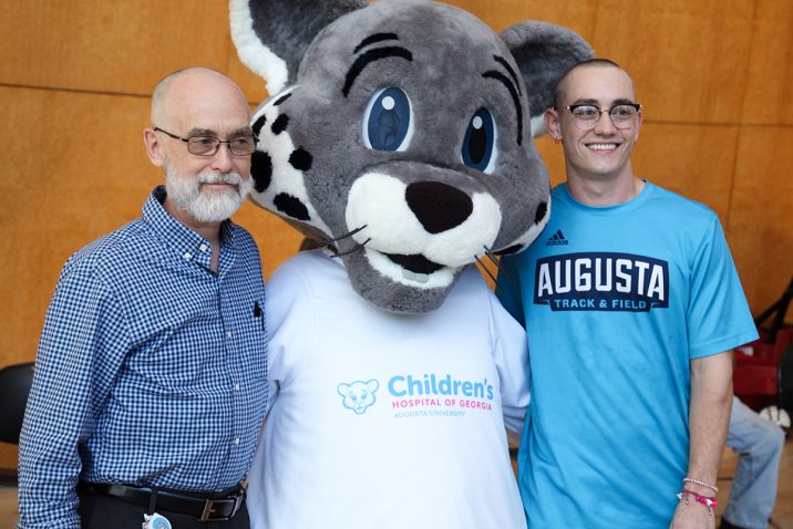 two men and a mascot