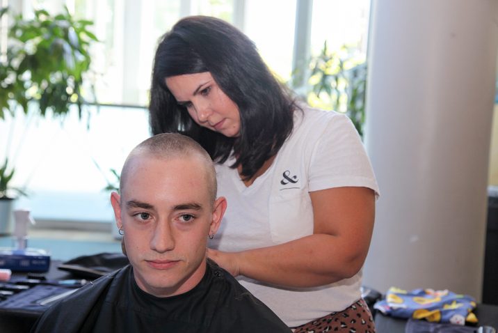 Person getting their haircut for fundraiser