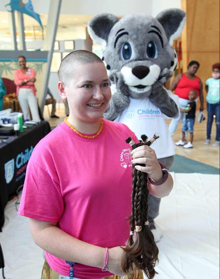 Person getting their haircut for fundraiser
