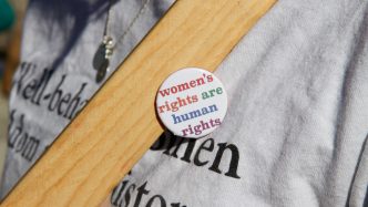 pin on shirt that says women's rights are human rights