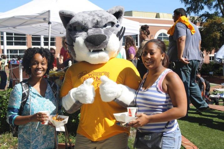 students smiling with mascot