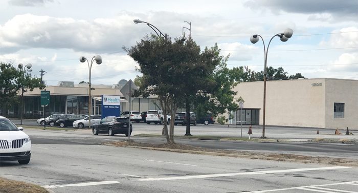 AU Health address sign says 1225 Walton Way and shows building, crosswalk and a few cars in parking lot