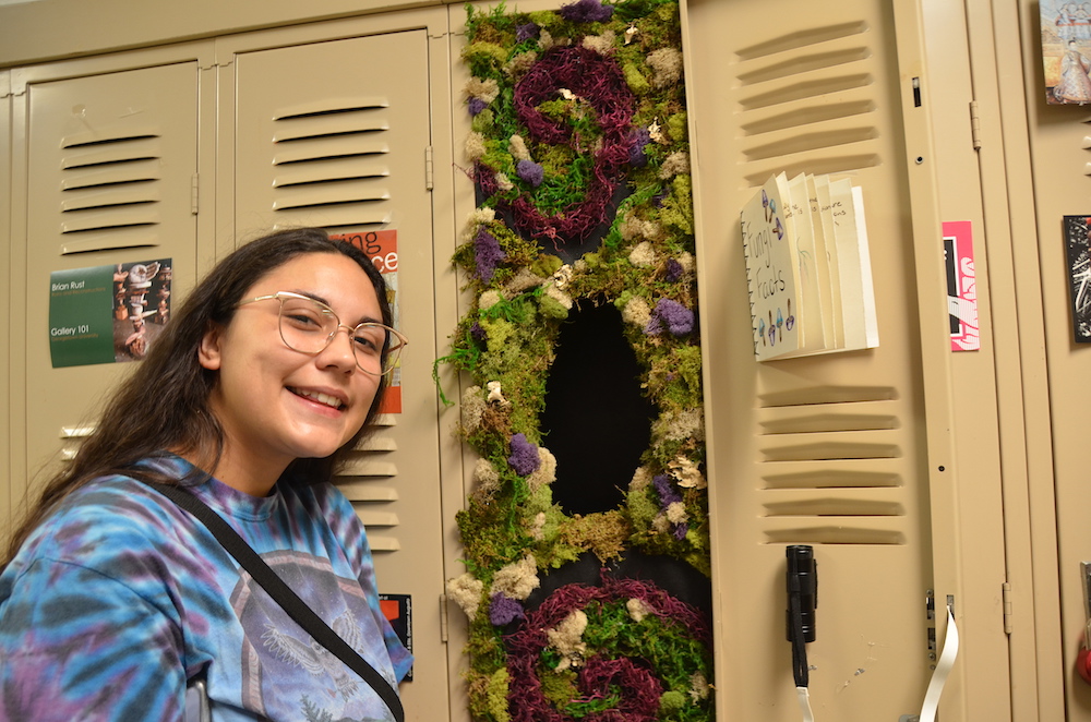 Woman standing by her locker.