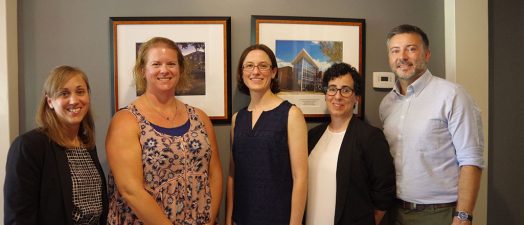 Four women and one man standing