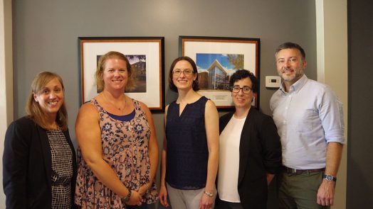 Four women and one man standing