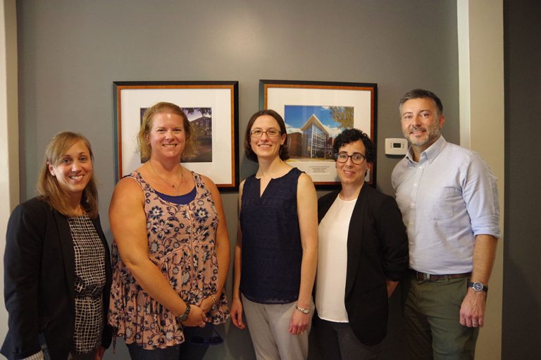 Four women and one man standing