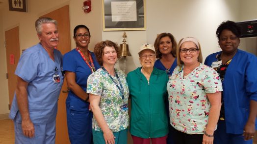 A woman surrounded by nursing staff at the Georgia Cancer Center