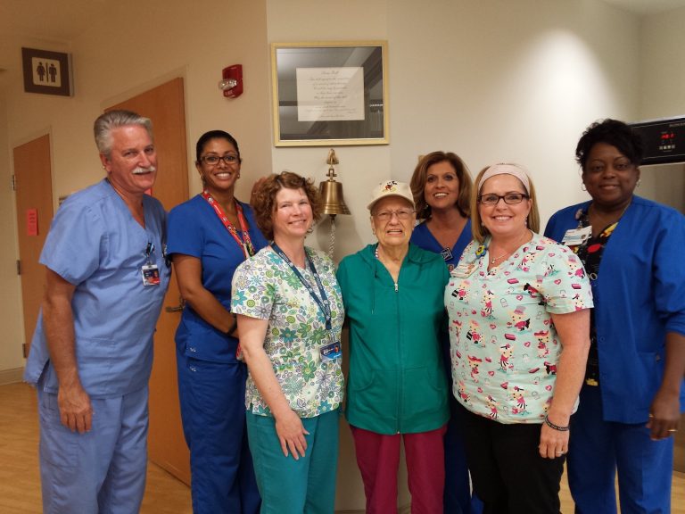 A woman surrounded by nursing staff at the Georgia Cancer Center