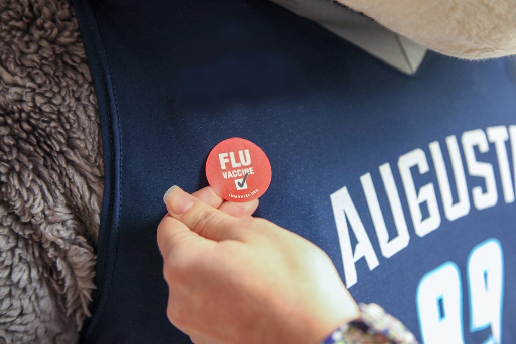 Image of red flu sticker on AU mascot Augustus's shirt