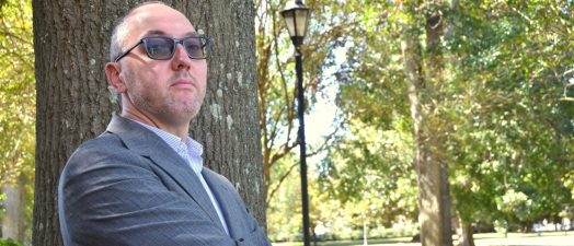 Man standing by tree.