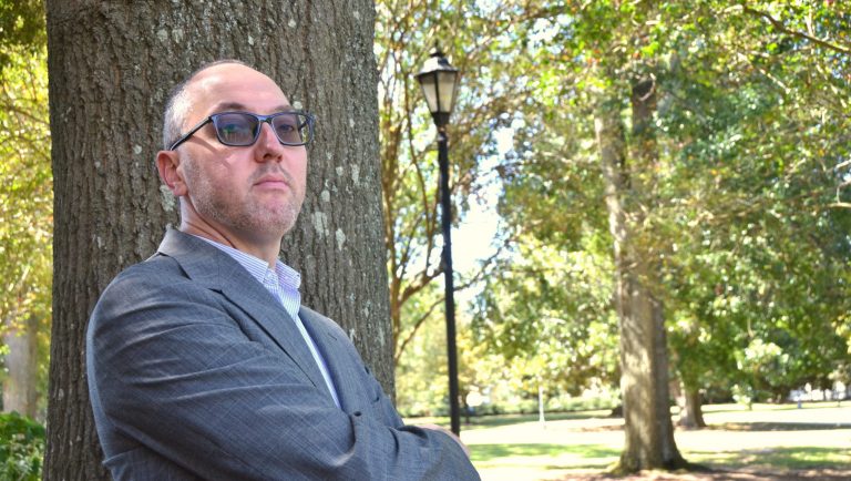 Man standing by tree.