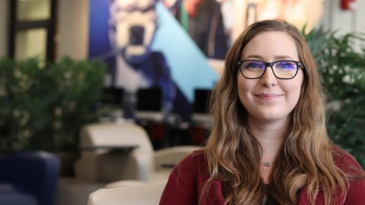girl student smiling for camera in Health Sciences Student Center.