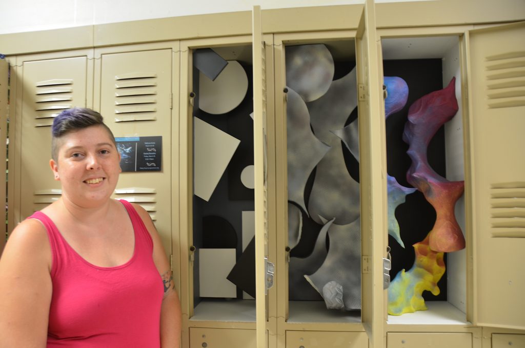 Woman standing by locker.