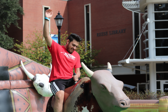 student riding mechanical bull