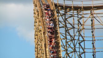 People going downhill on wooden rollercoaster