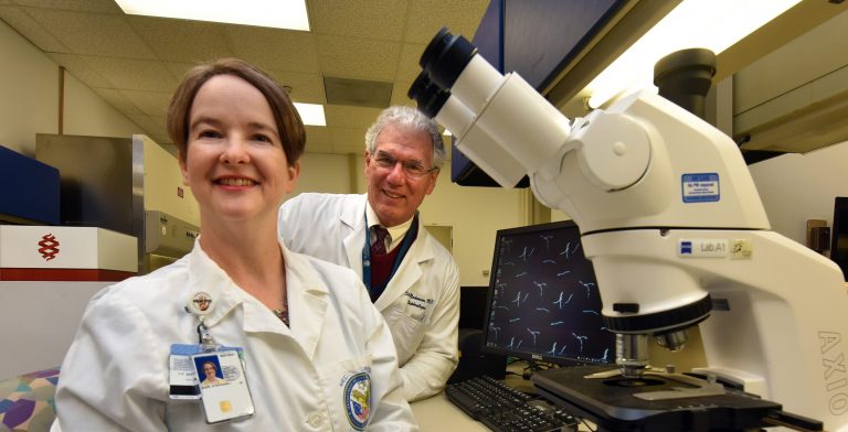 two doctors next to lab equipment