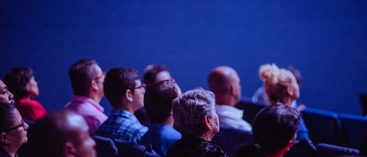 people sitting down watching a presentation