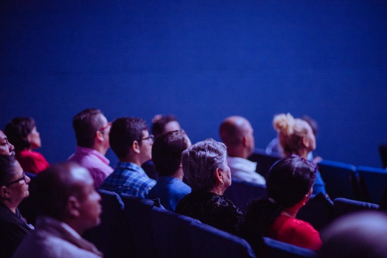 people sitting down watching a presentation
