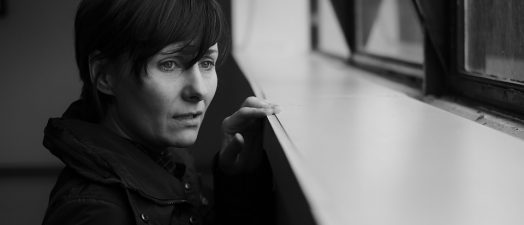 Woman looking out of a window.