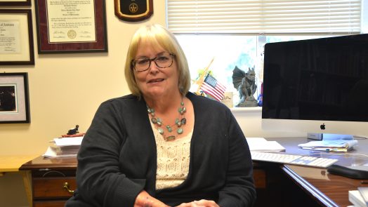 Woman sitting at a desk.