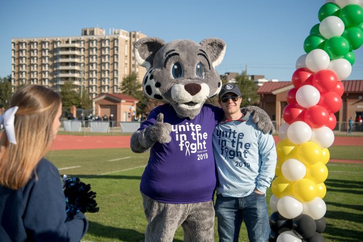 A walk participant poses with Roary.