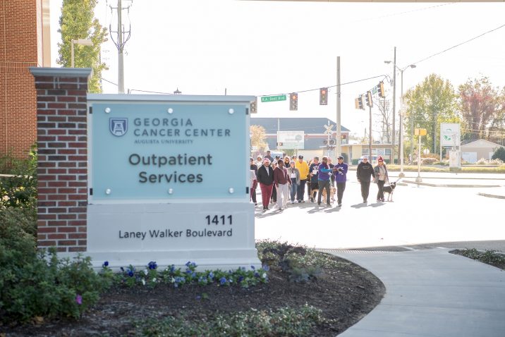 A photo of people walking by the Georgia Cancer Center's Outpatient Services clinic.