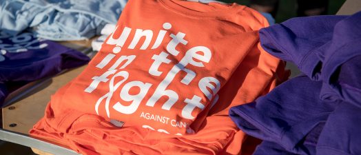 A picture of a t-shirt showing the Unite in the Fight Against Cancer logo