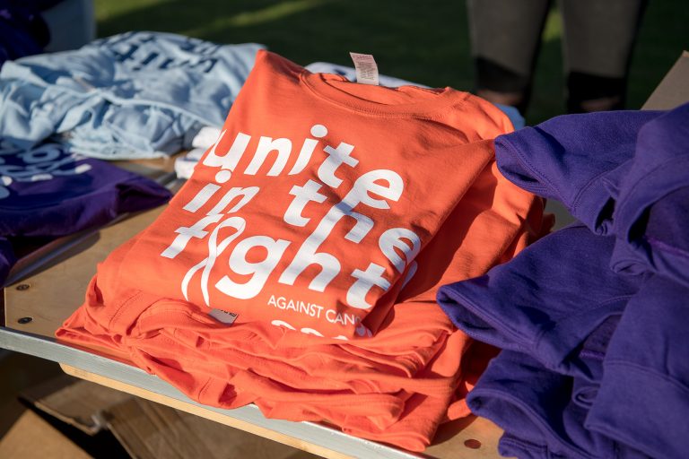 A picture of a t-shirt showing the Unite in the Fight Against Cancer logo