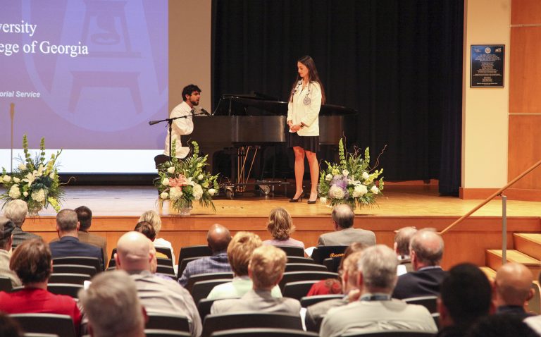 Man plays piano and woman sings
