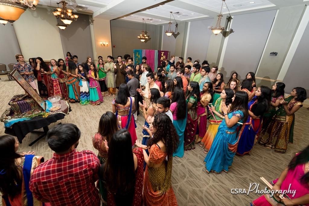 Group of students dancing, wearing traditional Indian attire