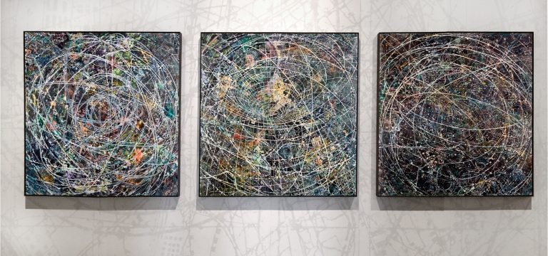 Three paintings on a wall.