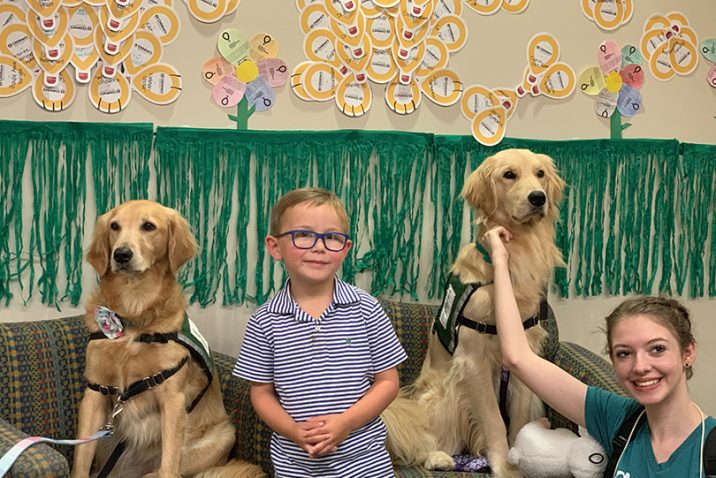 dogs sitting with a boy and girl