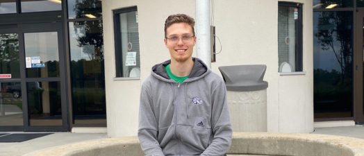 man sitting while posing for a photo