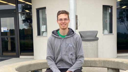 man sitting while posing for a photo
