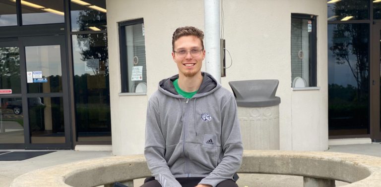 man sitting while posing for a photo