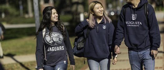 3 students wearing Augusta University shirts