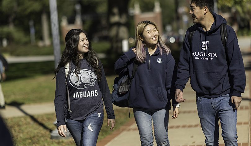 3 students wearing Augusta University shirts