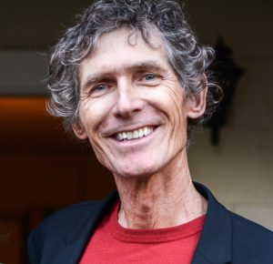 headshot photo of a man smiling