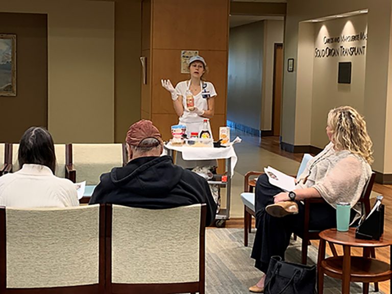 Woman with cart talks to people