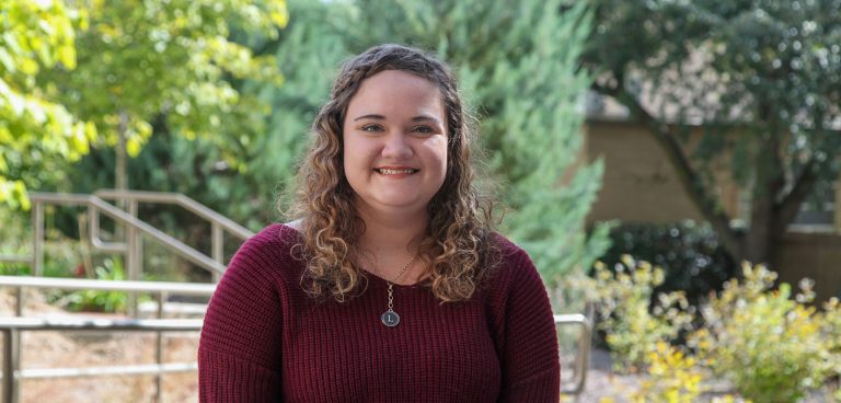woman posing for a photo outside