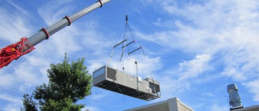 crane lifts chiller over building