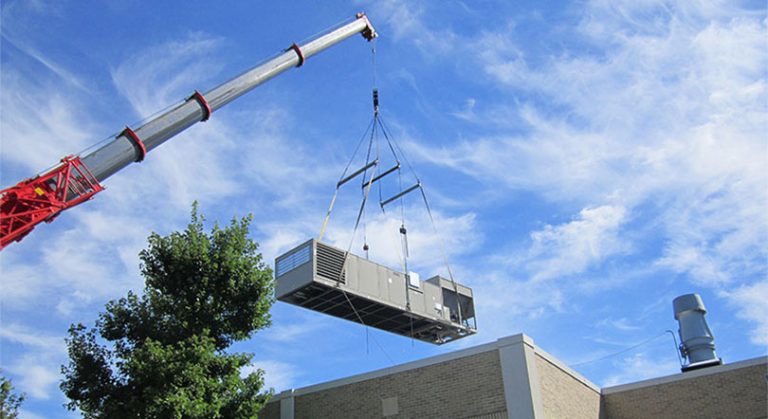 crane lifts chiller over building