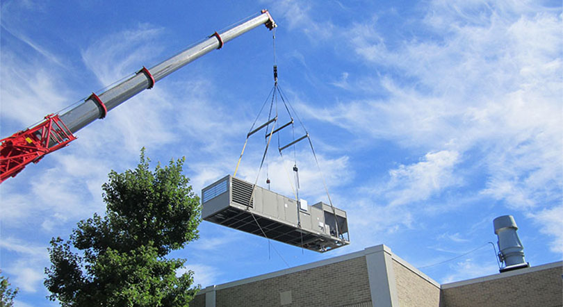 crane lifts chiller over building